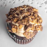 Peanut Butter Cup · Chocolate cake topped with peanut butter buttercream and rolled in crushed peanut butter cups.
