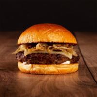 The Swiss Burger · Beef patty, caramelized onions, mayo, and melted swiss cheese on a brioche bun.