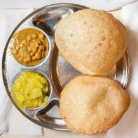Poori · Fried fluffy whole wheat bread served with two curries.