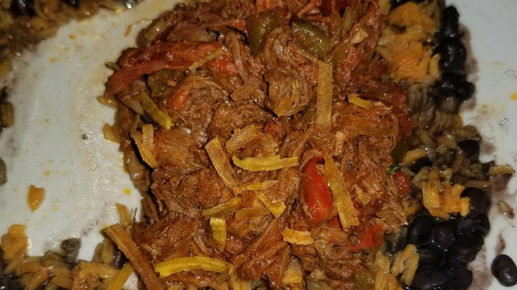 Ropa Vieja · Braised shredded steak with onions, bell peppers & plum tomatoes.