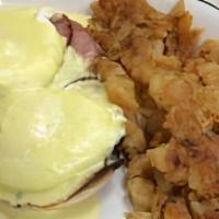 Eggs Benedict · Two poached eggs on an English muffin with Canadian bacon and hollandaise sauce, served with...