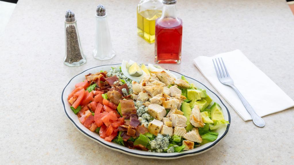 Goodman’S Cobb · New. Crisp romaine topped with grilled marinated chicken, bacon, bleu cheese crumbles, tomato, avocado, hard-boiled egg, and poppy seed dressing.