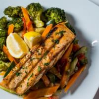 Grilled Salmon · Served with spinach, broccoli and garlic and oil.