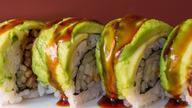 Dragon Roll · Eel, cucumber with avocado, and smelt roe on top eight pieces.
