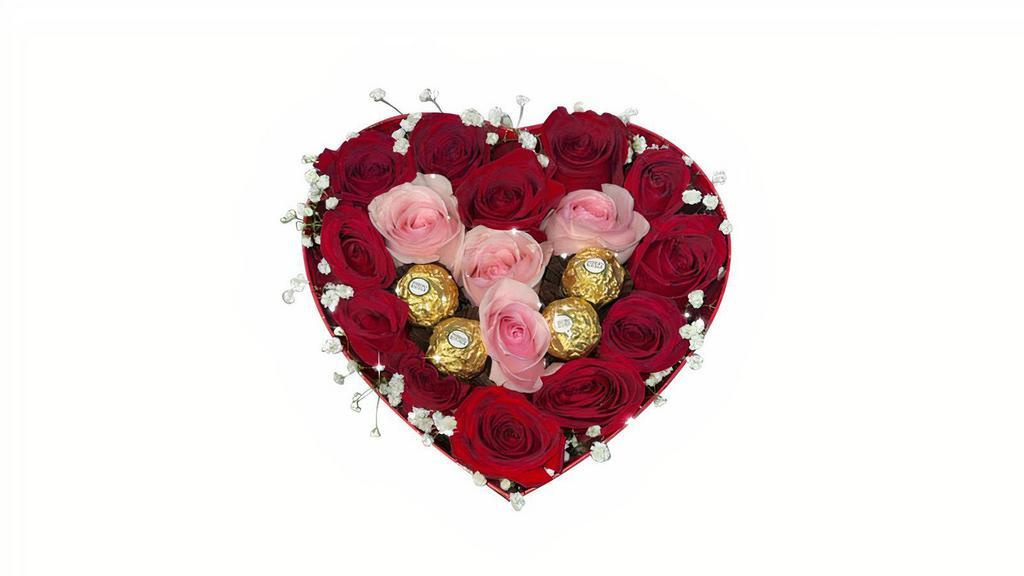 Precious Heart · Pink and red roses and chocolates arranged in a heart shaped can.