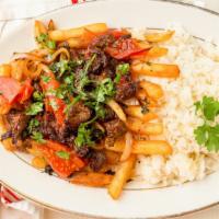 Lomo Saltado · Stir fried steak with tomatoes, onions rice, and fries.