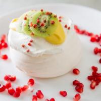 Rosewater Pavlova · Passion fruit curd, kiwifruit & fresh whipped cream.