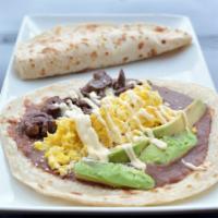 The Super Baleada · Flour tortilla stuffed with beans, cheese, cream, eggs, roasted meat, sausage and avocado.