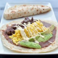 Baleada With Pork Meat · Flour tortilla stuffed with pork meat, beans, cheese, cream, and avocado.