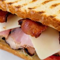 Turkey Club Panini · Turkey, bacon, cheese, lettuce and tomatoes.