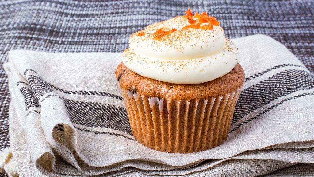 Carrot Cake · Yellow cake with carrots, cinnamon and nutmeg baked inside, cream cheese icing with cinnamon and carrots on top.