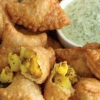 Vegetable Samosa · Triangular patties with seasonal potatoes and peas (two in one order).