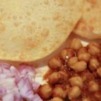 Chana Bhatura · Fluffy white bread served with chickpeas masala.