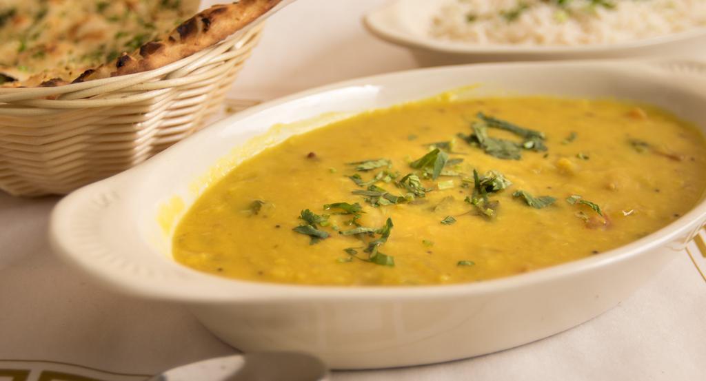 Tadka Daal (Spinach) · Loosened Yellow Lentils Cooked With Spices, Spinach, Green Chili, Cumins, And Onions.