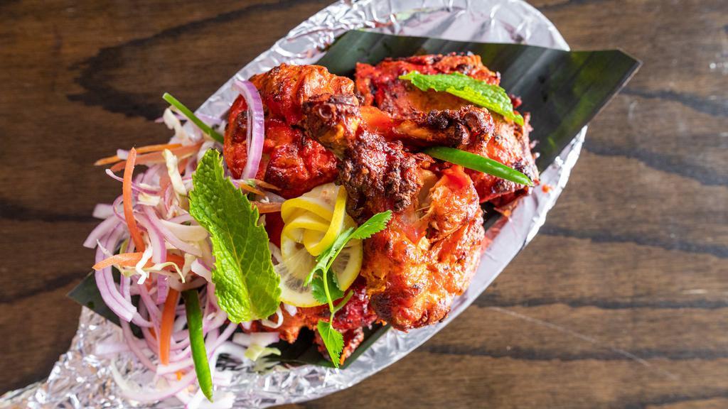 Kodi Tandoori - Chicken Tandoori · Chicken leg and thigh pieces are marinated overnight in yogurt with herbs, spices and cooked on skewers in tandoor.