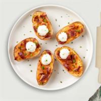 Crispy Spud Skin · Crispy potato skins topped with cheddar cheese, bacon, and sour cream.
