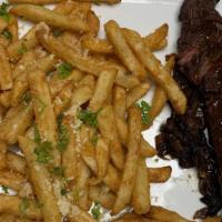 Steak Frites · Grilled hanger steak, umami onions, demi glaze, truffle fries.