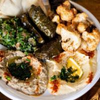 Mixed Vegetarian Platter · Hummus, baba ghanoush, tabbouleh, fried cauliflower, eggplant, pita bread.