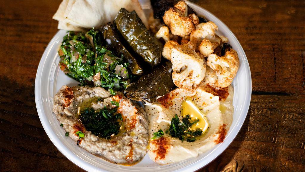Mixed Vegetarian Platter · Hummus, baba ghanoush, tabbouleh, fried cauliflower, eggplant, pita bread.