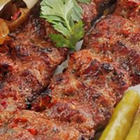 Beef Kabab · 2 skewers of beef kabab served with rice or fries, home salad, hummus, and bread.