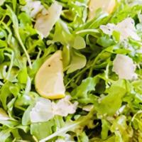 Lemon Arugula Salad · Arugula, shaved Italian cheese, coal oven baked croutons and lemon vinaigrette garnished wit...