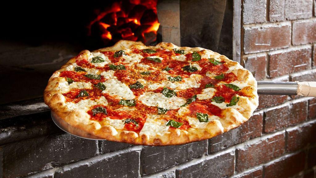 Margherita · Traditional pizza with extra famous sauce and fresh basil.