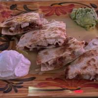 Colorado Quesadilla · Flour tortilla stuffed with chicken, bacon, and cheese. Served with sour cream and guacamole.