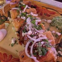 Flautas · Shredded chicken and potatoes in lightly fried flour tortillas topped with a roasted salsa a...