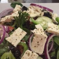 Greek Salad · Mixed greens, tomatoes, black olives, green peppers, cucumbers, feta cheese, stuffed grape l...