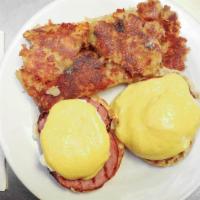 Eggs Benedict · Two lightly toasted English muffin halves, each topped with a slice of Canadian bacon, poach...