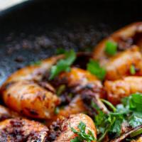 Shrimp By The Pound · EZ peel headless shrimp, shaken in our homemade spiced garlic butter and served with corn, r...
