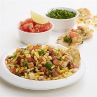 Bhel Puri · The spicy dish of puffed rice, onions, spices, and hot chutney.