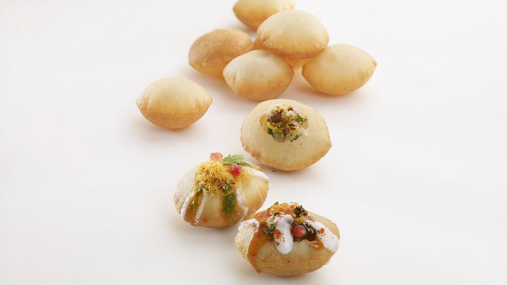 Dahi Puri · Crispy sphere-shaped balls stuffed with diced boiled potatoes and sprouted black gram, garnished with yogurt, tamarind and mint sauce.