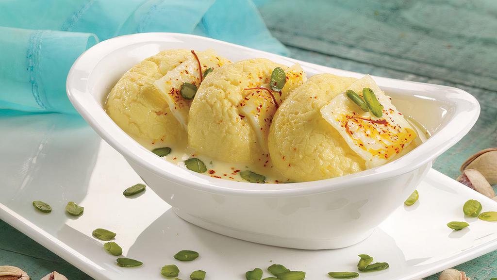 Rasmalai (2 Pcs.) · Delicate round shape Cottage cheese patties soaked in thick milk flavored with cardamom and saffron.