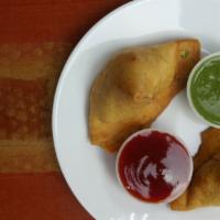 Samosa Veg (2 Pieces) · Crispy fried turnover, deliciously filled with medium hot spices potatoes & green peas.