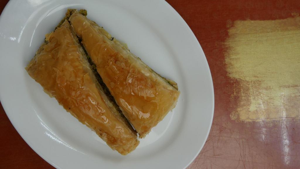 Baklava · Sweet pastry made of extremely thin sheets of fillo dough layered with chopped nuts and honey syrup baked with butter.