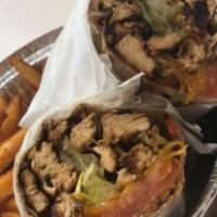 Greek Salad With Grilled Chicken Wrap · Grilled chicken tender are overstuffed in a wrap with crisp Greek salad a blend of iceberg l...