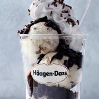 Mint Chip Dazzler® Sundae · Mint chip ice cream layered with hot fudge and chocolate cookie pieces topped with whipped c...