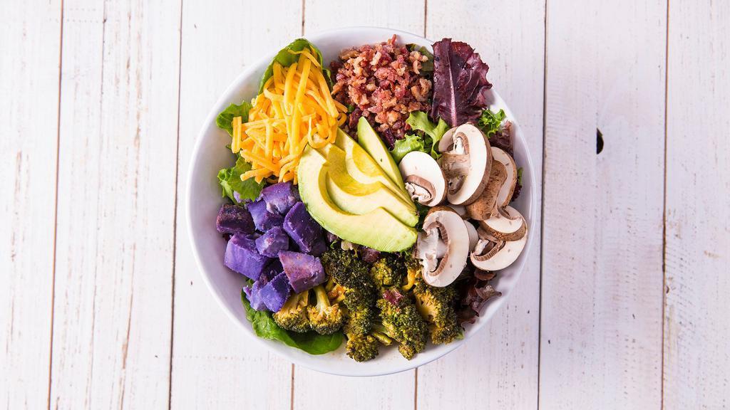 Paniolo · Spring mix, avocado, cheddar, mushrooms, bacon, purple sweet potatoes, kimchi broccoli, and cilantro-smoked chili vinaigrette.