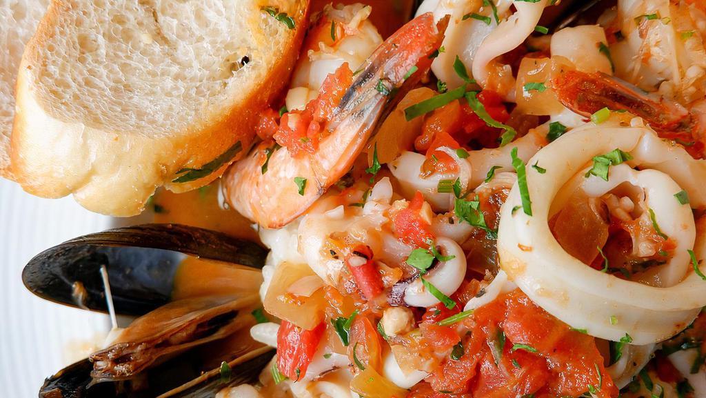 Seafood Risotto · Shrimp, calamari, mussels, homemade tomato sauce