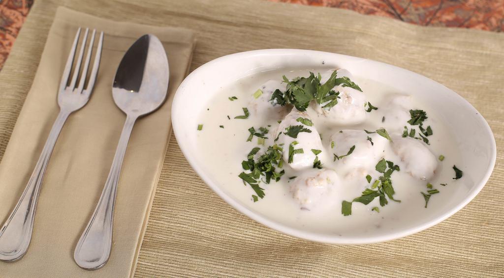 #53. Dahi Wada · Lentil balls served in yogurt and topped with tamarind chutney.