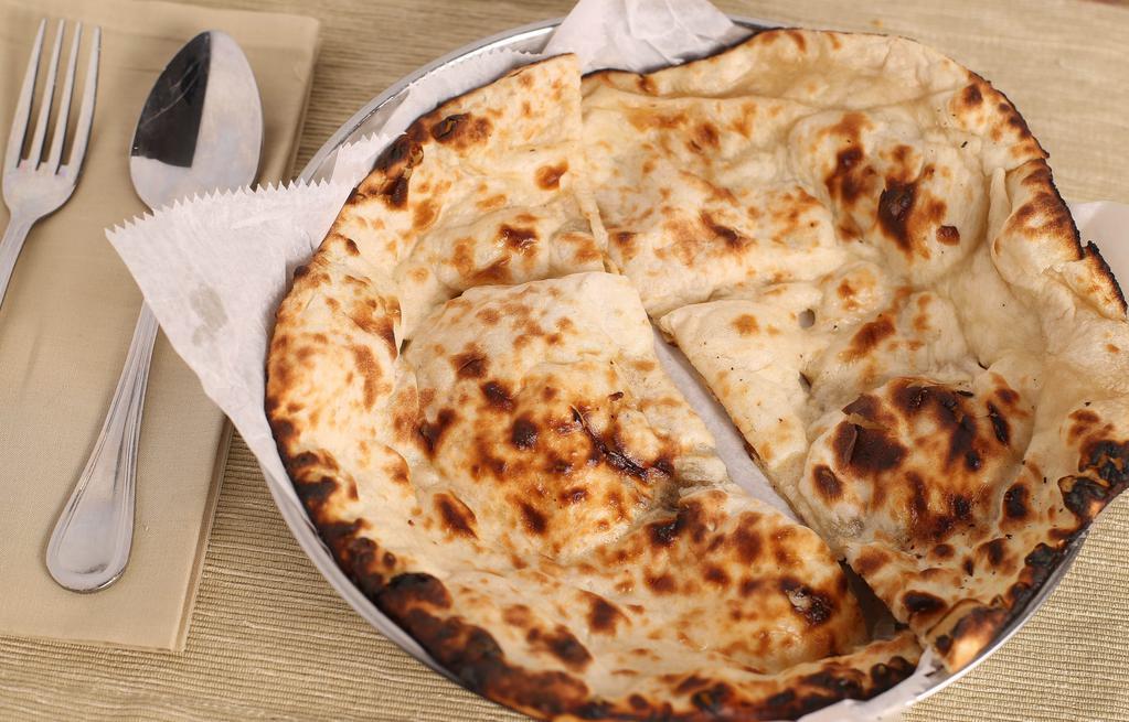 Naan · Traditional Punjabi style tear-drop shaped white bread baked on the sides of our tandoori oven, delicious with or without butter.