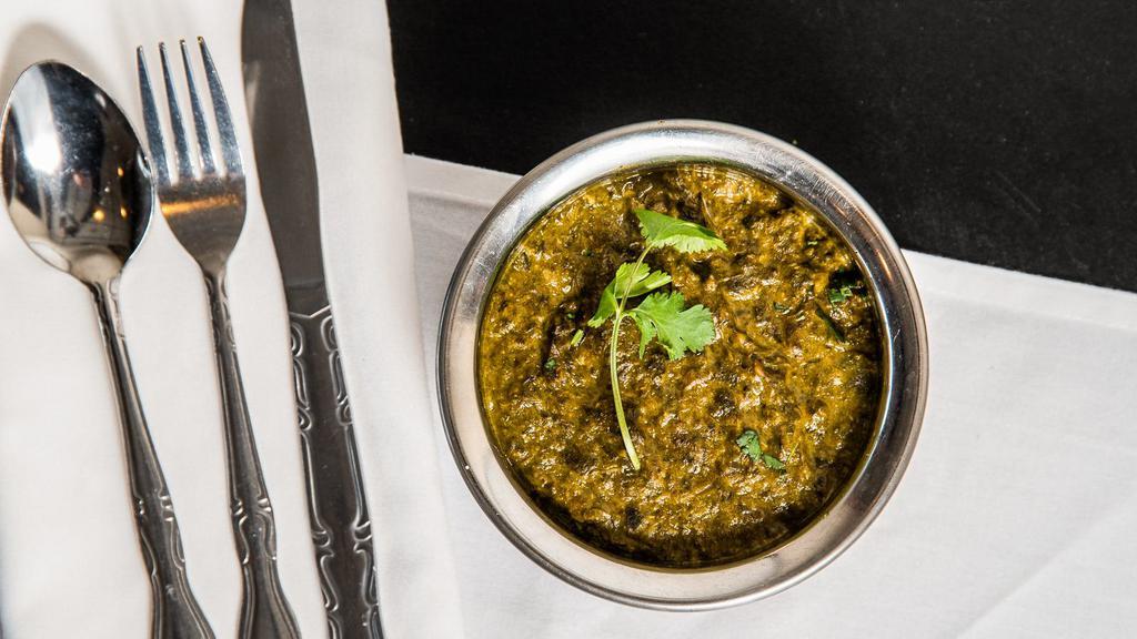 Saag Panir · Spinach with homemade cheese cooked in spices.