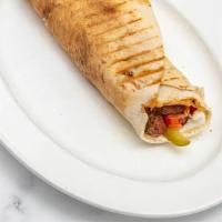 Sojuk Pita Sandwich · Spiced Lebanese beef and lamb sausage flambeed in lemon juice, garlic toum, pickles and tomato