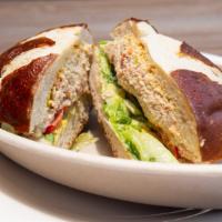 Tuna Melody · House tuna, red pepper, tomato, romaine lettuce, red onion, honey tinted mustard on mezonos ...