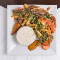 Lomo Saltado · Stir-fried pork loin, onions tomatoes, spices, French fries. Served with fried plantains and...