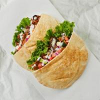 Beef And Lamb Shawarma Pita · Mixed beef & lamb shawarma with tomatoes, cucumber, onions, and your choice of sauce wrapped...