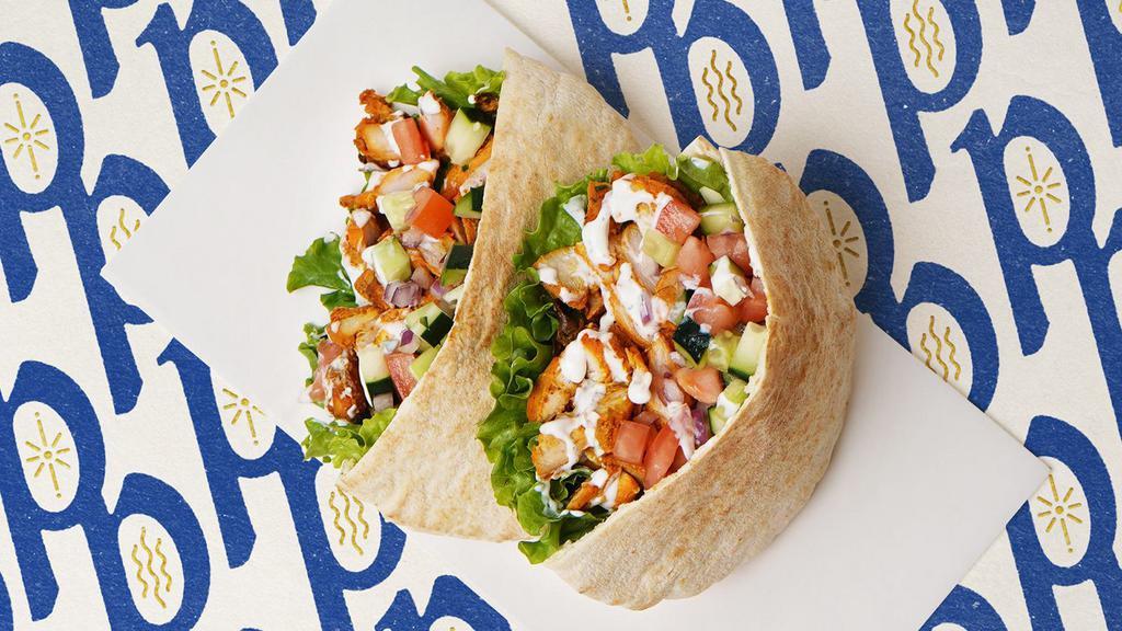 Chicken Shawarma Pita · Chicken shawarma with lettuce, tomatoes, cucumber, onions, and your choice of sauce wrapped in a pita.
