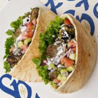 Beef Kabob Pita · Marinated beef with lettuce, tomatoes, cucumber, onions, and your choice of sauce wrapped in...