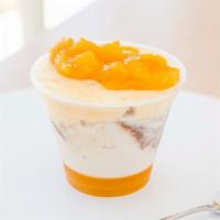 Mango Tres Leches · Mango purée layer, tres leches layer, mango mousse layer, and all topped with fresh cut mango.
